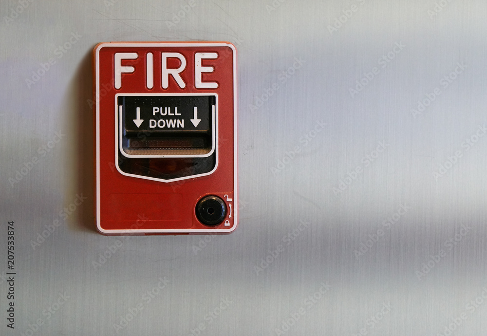 Manual fire alarm pull station on brushed steel wall Stock Photo ...