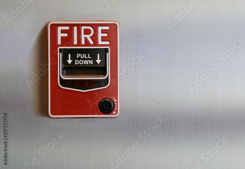 Manual fire alarm pull station on brushed steel wall