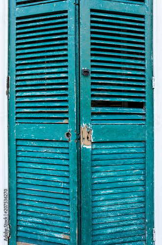 Closeup of old green blue turquoise door shutter