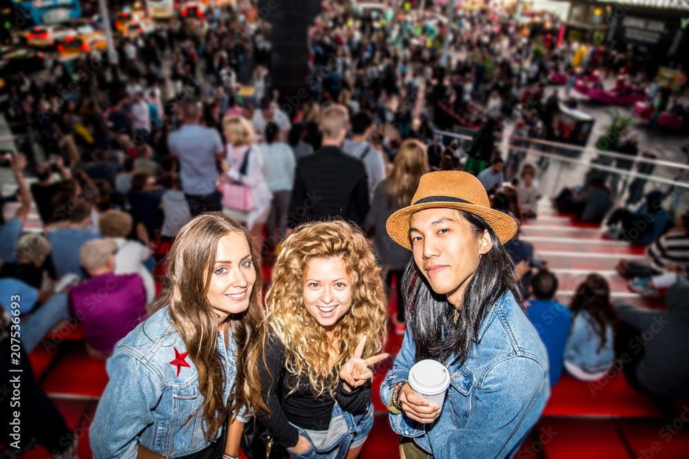 Friends taking selfie in Times Square Friends taking selfie in Times Square