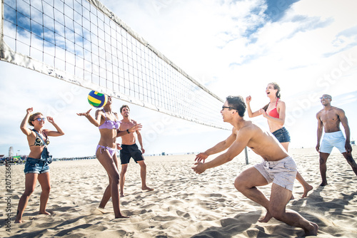 Friends play beach volley