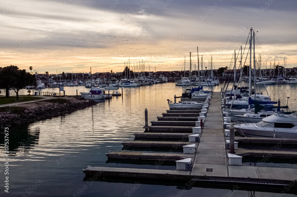 Many boats on marina during sunrise in Oxnard, California
