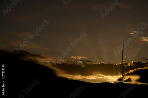 Broadcast antenna silhouette with dramatic sunrise behind