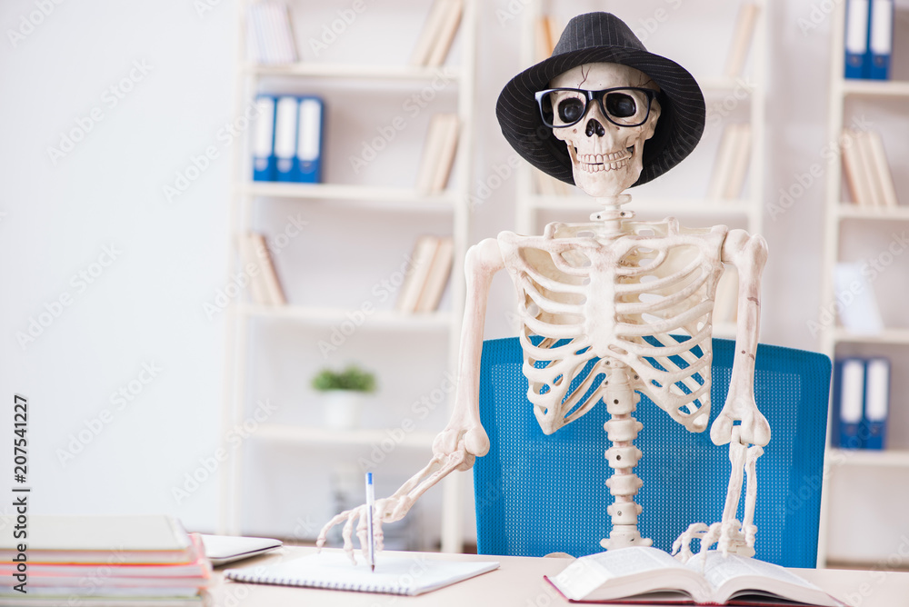 Skeleton businessman working in the office Skeleton businessman working in the office