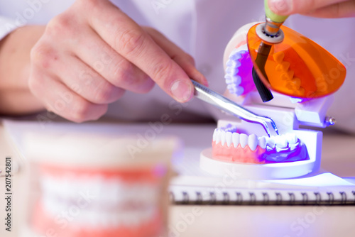 Dentist working teeth implant in medical lab photo