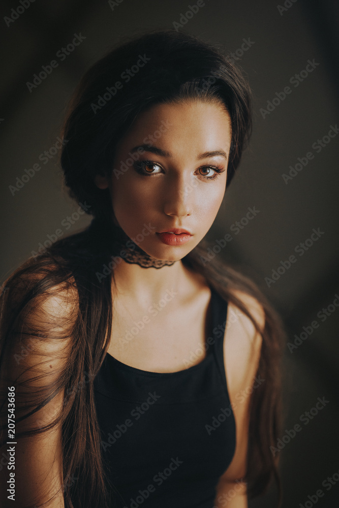 Fototapeta premium Portrait of beautiful young brunette woman with makeup