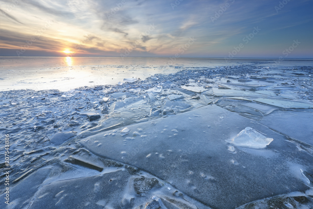 sunset over shelf ice on frozen lake