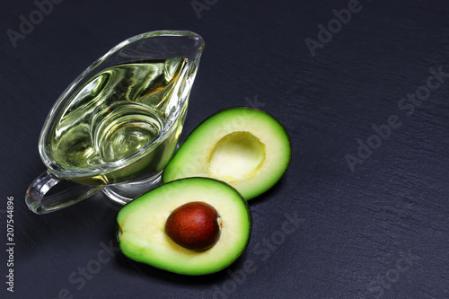 Green avocados and avocado oil on a shale board, the concept of healthy eating, copy space, top view set