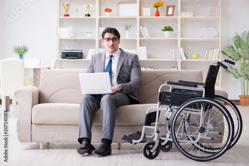 Dsabled businessman on wheelchair working home © Elnur