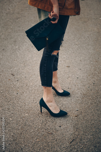 street style fashion details, chic blogger posing in trendy clothes. close up of a elegant handbag, suede leather purse. ideal fall or autumn outfit. 