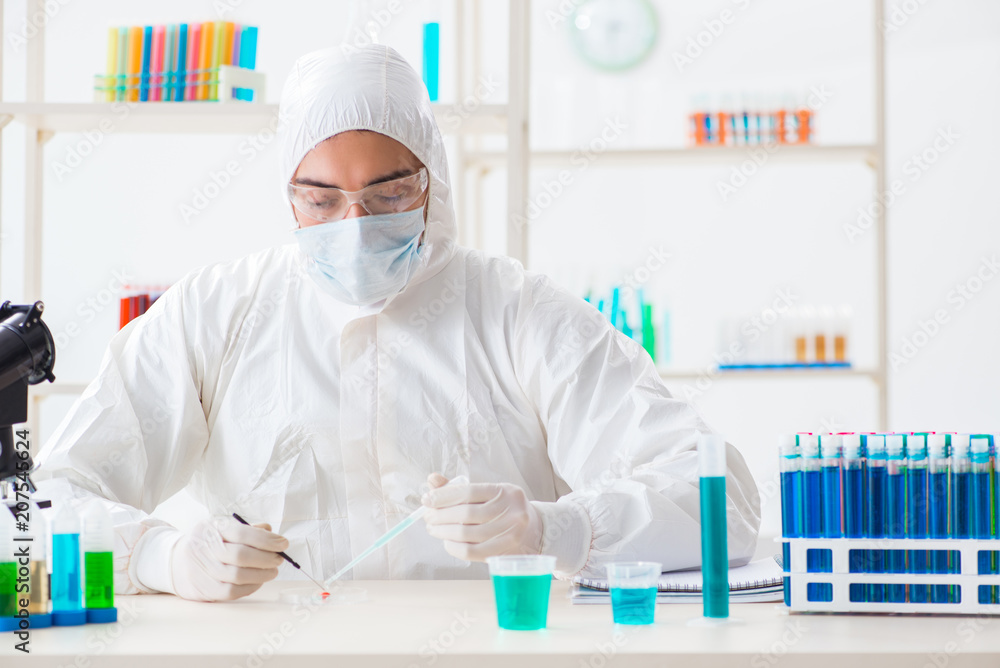 Young chemist student working in lab on chemicals Young chemist student working in lab on chemicals