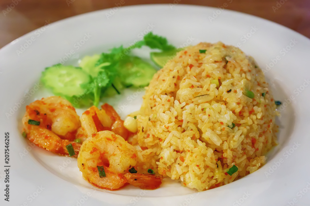 Fried Rice with Shrimp Paste in white dish on the wooden floor. Fried Rice with Shrimp Paste in white dish on the wooden floor.