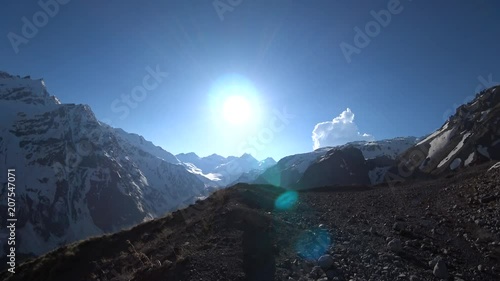 Snowy mountains view with a blue sky background