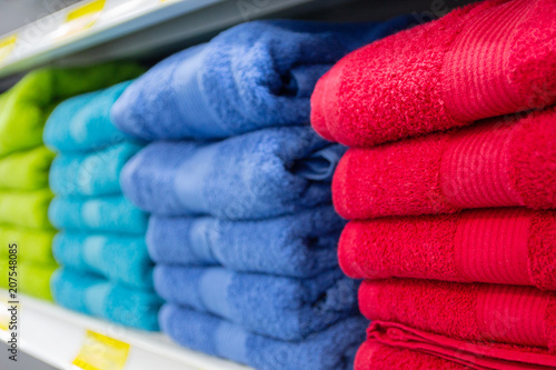 Colorful bath towels on the counter of the store close up. Sales