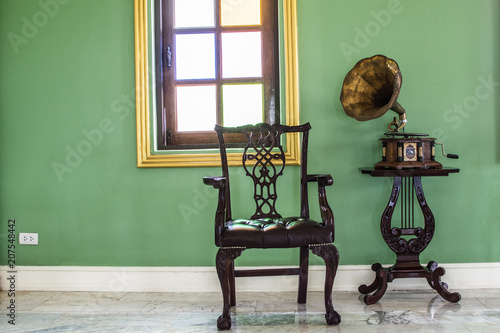 Antique record player and a chair in the corner.