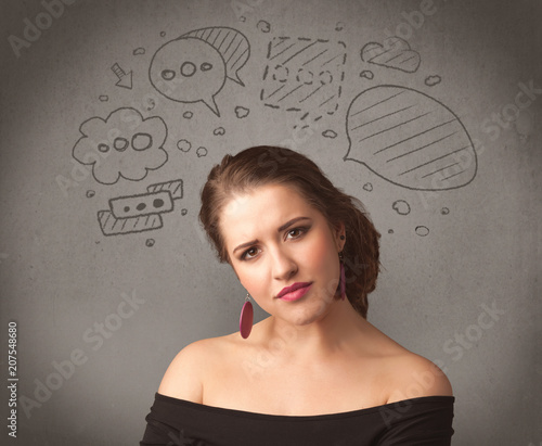 A cute female student making funny expressions with thoughts in her head illustrated by drawn chat bubbles on the urban wall background concept.