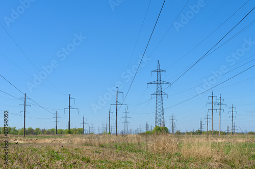 power lines in a field with dry grass
