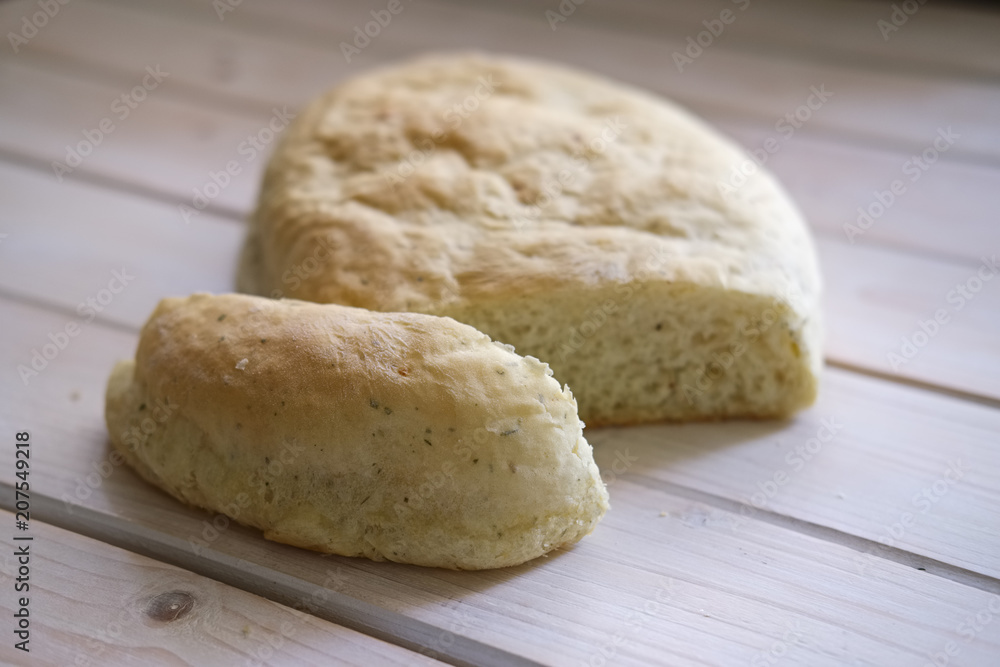 Fototapeta premium Freshly baked homemade white bread with herbs