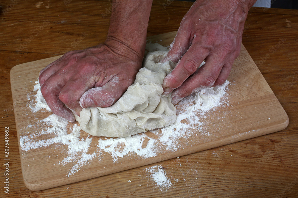 Baker preparing some dough ready to bake some bread Baker preparing some dough ready to bake some bread