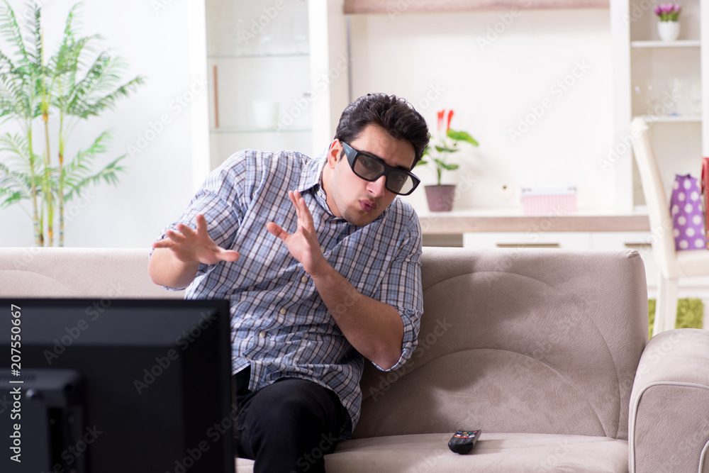 Man watching 3d tv at home Man watching 3d tv at home