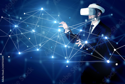 Businessman in virtual reality goggles investigate global network connectivity concept
