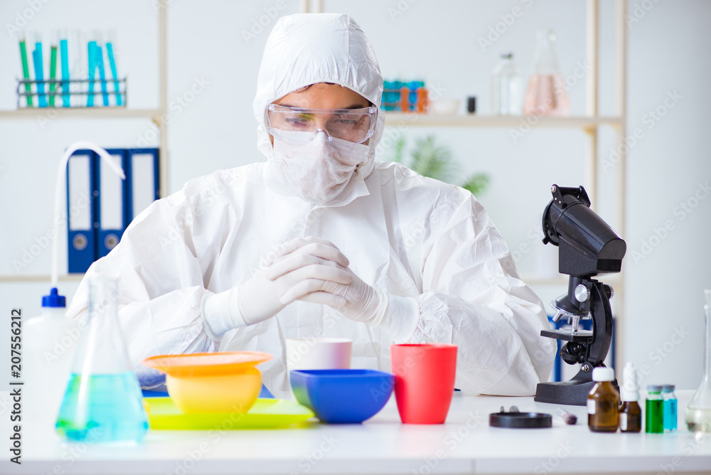 Chemist checking and testing plastic dishes Chemist checking and testing plastic dishes