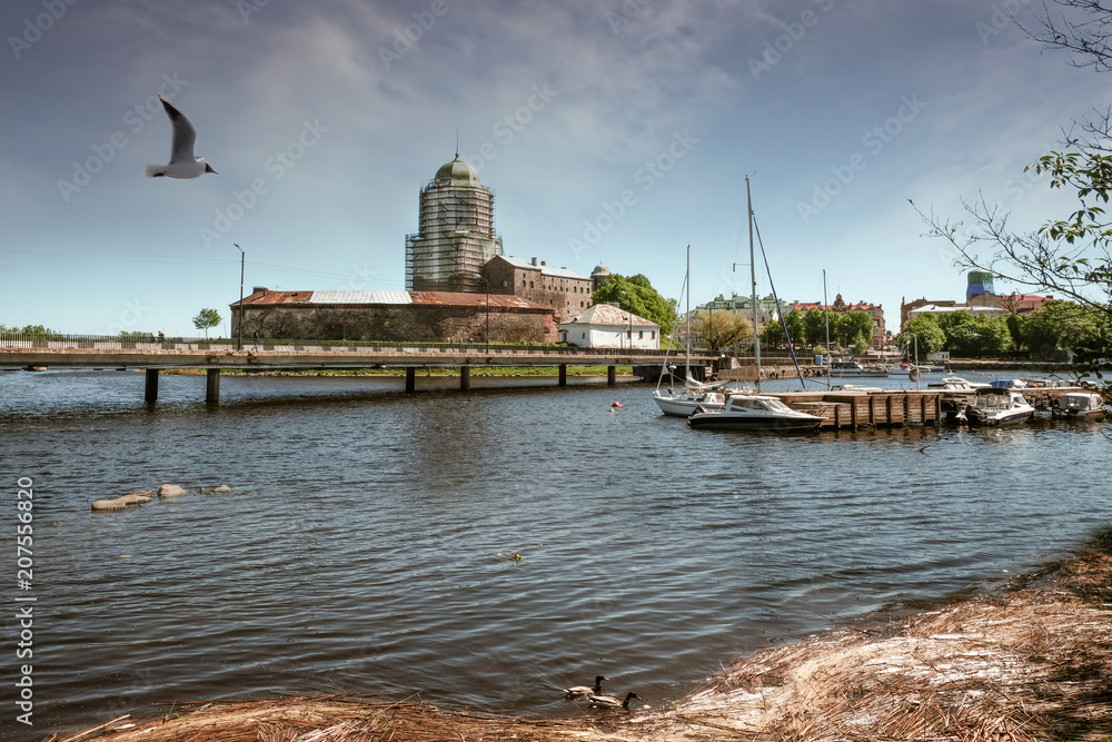  port of Vyborg on the background of an ancient medieval castle