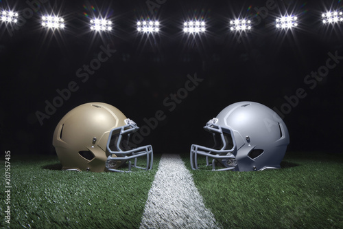 Canvastavla Football helmets facing off on a yard line below stadium lights at night