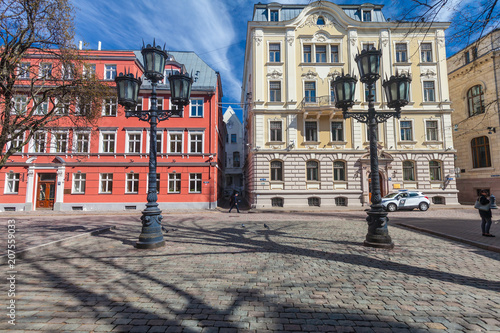 View on the colored cozy old houses and street lamps that are located in the city center of Riga. Latvia.