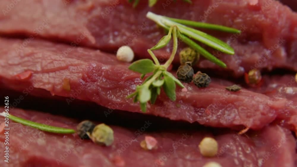 raw beef fillet with pepper and thyme, ready to grill. Rotation raw beef fillet with pepper and thyme, ready to grill. Rotation