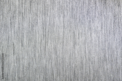Close up industrial background of fractally scratched direct vertical lines to silver metal/stainless steel surface. Creative detail macro photography. © Martin