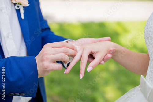 The bride and groom put on rings to each other