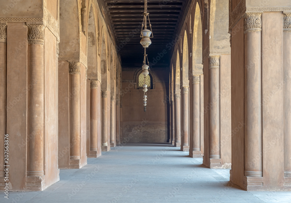 Corridor surrounding the courtyard of the Mosque of Ahmad Ibn Tulun framed by huge decorated arches, old Cairo, Egypt Corridor surrounding the courtyard of the Mosque of Ahmad Ibn Tulun framed by huge decorated arches, old Cairo, Egypt