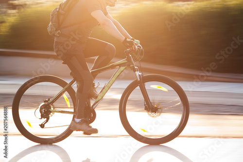 man on a bicycle in a summer sunny city