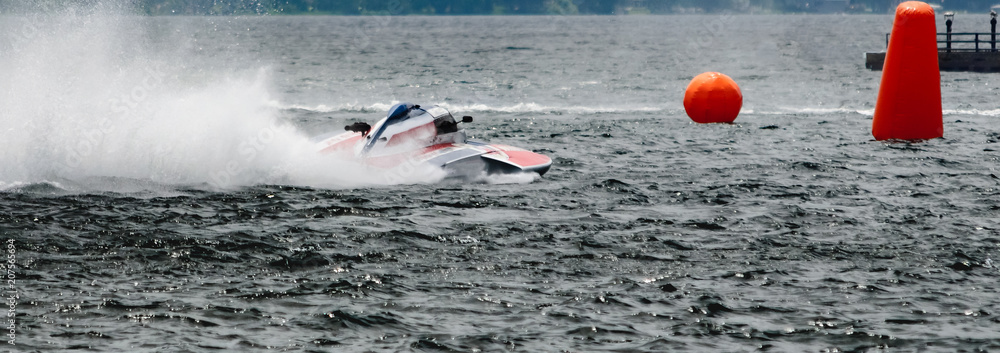 Εκτύπωση καμβά Red and white hydroplane racing boat on river heading towards orange bouys