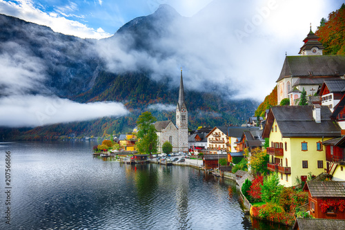 Scenic view of famous Hallstatt mountain village with Hallstatter lake See in beautiful golden morning light in fall © pilat666