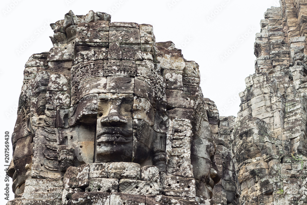 Stone face tower of ancient buddhist temple Bayon in Angkor Wat complex, Cambodia. Ancient architecture