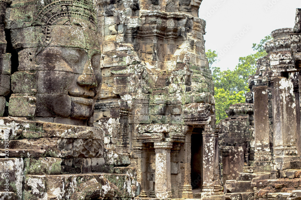 Carved stone face of ancient buddhist temple Bayon in Angkor Wat complex, Cambodia. Cambodian place of interest