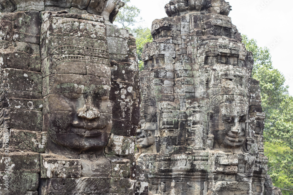 Stone face smile of ancient buddhist temple Bayon in Angkor Wat complex, Cambodia. Khmer art.