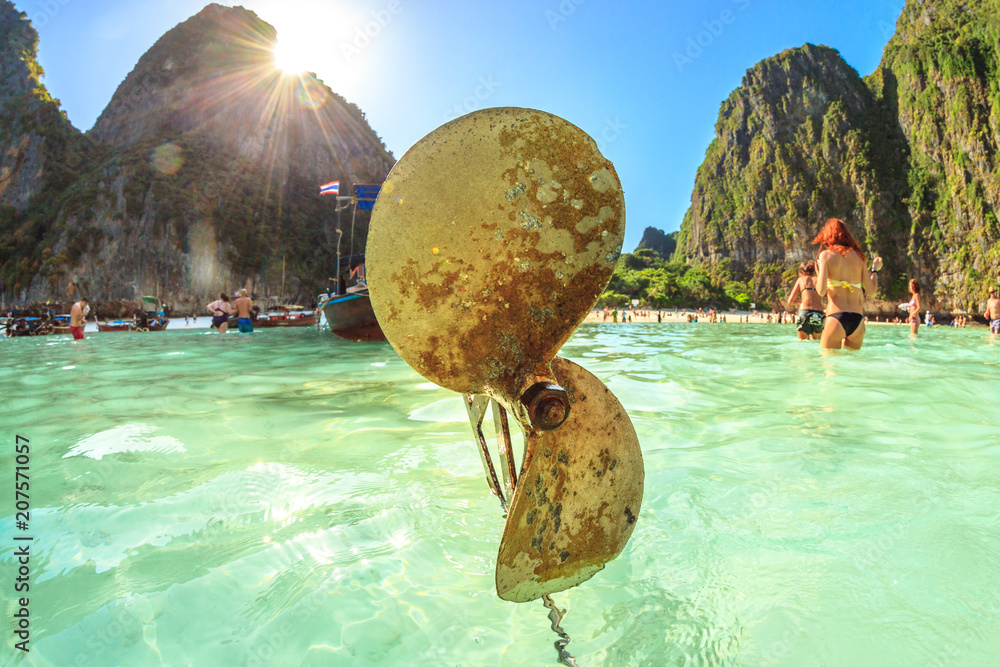 Fototapeta premium Closeup of propeller of a traditional longtail boat in Maya Bay lagoon, Phi Phi island, Andaman Sea, Thailand. Mass tourism has damaged and polluted the paradisiac island of Ko Phi Phi Leh.