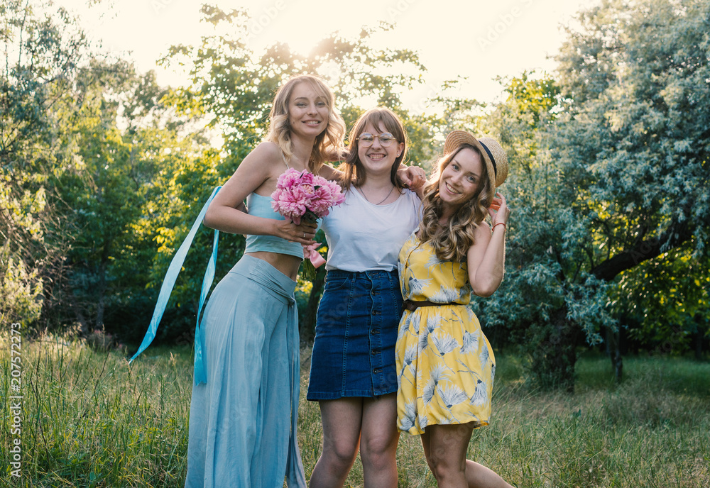 Naklejka premium Three girls friends outdoor in the park or forest. bachelorette, party