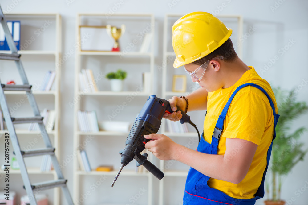 Young repairman with power drill Young repairman with power drill