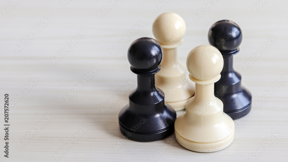 Two white chessman and two black chessman. Two white chessman and two black chessman.