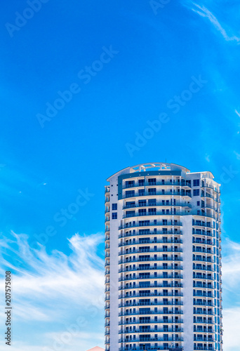 White Condo Tower Under Blue Tropical Sky