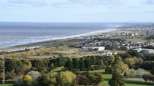 Pensarn beach and Abergele, British village in wales, overlooking the town, Pensarn beach with sea on the horizon, showing trees, fields and traffic from a high distant vantage point, Sandy beach.