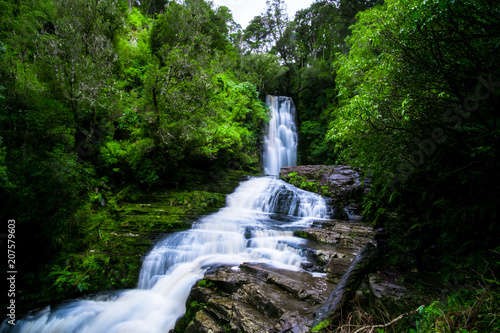 Long Exposure photography. Beautiful waterfall in the rainforest with green nature. Purakaunui Falls  The Catlins  New Zealand.