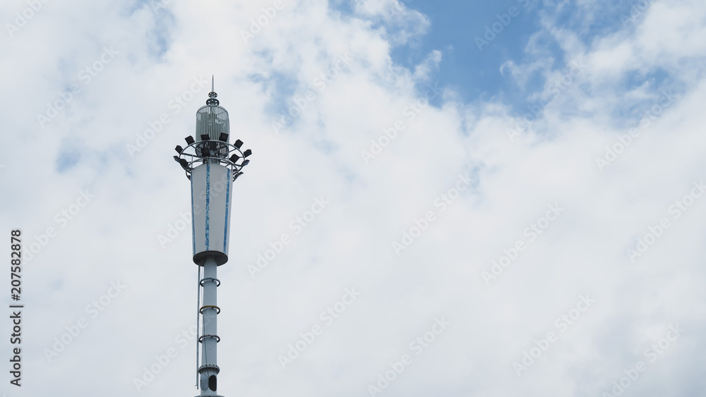 Closeup Shot of Chinese Self Support Mobile / Cellular Phone System Antenna on Blue Sky and White Clouds Background.