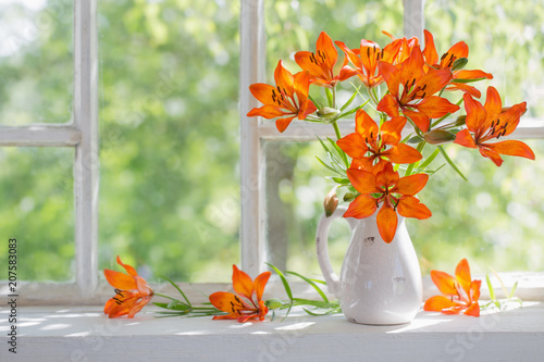 Fototapeta Naklejka Na Ścianę i Meble -  orange lily on windowsill