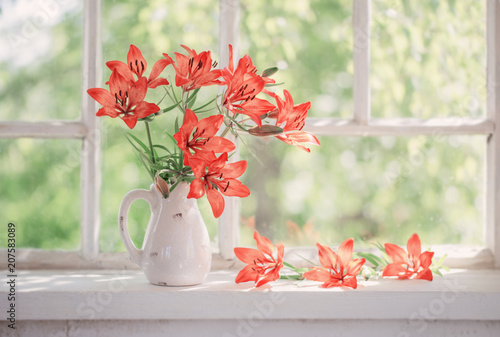 Fototapeta Naklejka Na Ścianę i Meble -  orange lily on windowsill