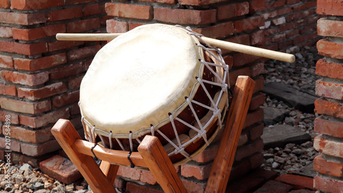 Brick wall and traditional drum. photo